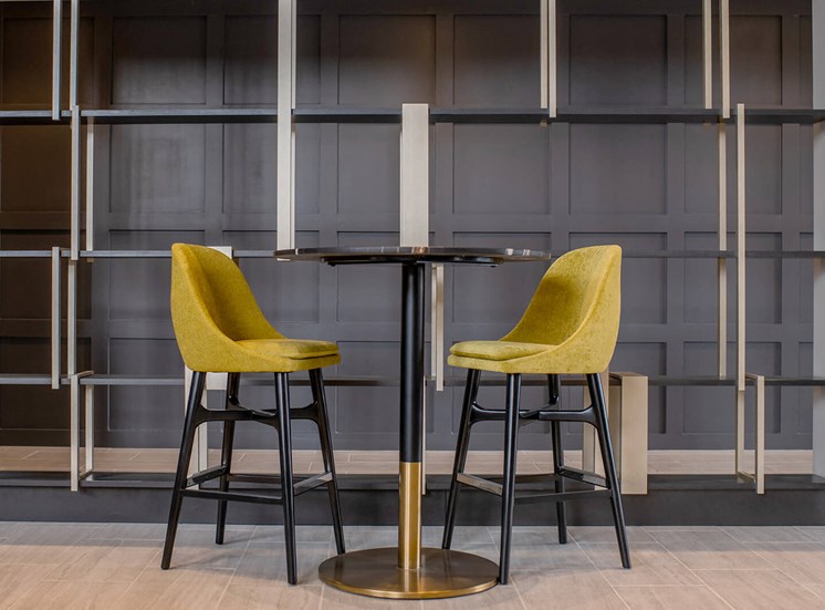 two barstools around a high top table